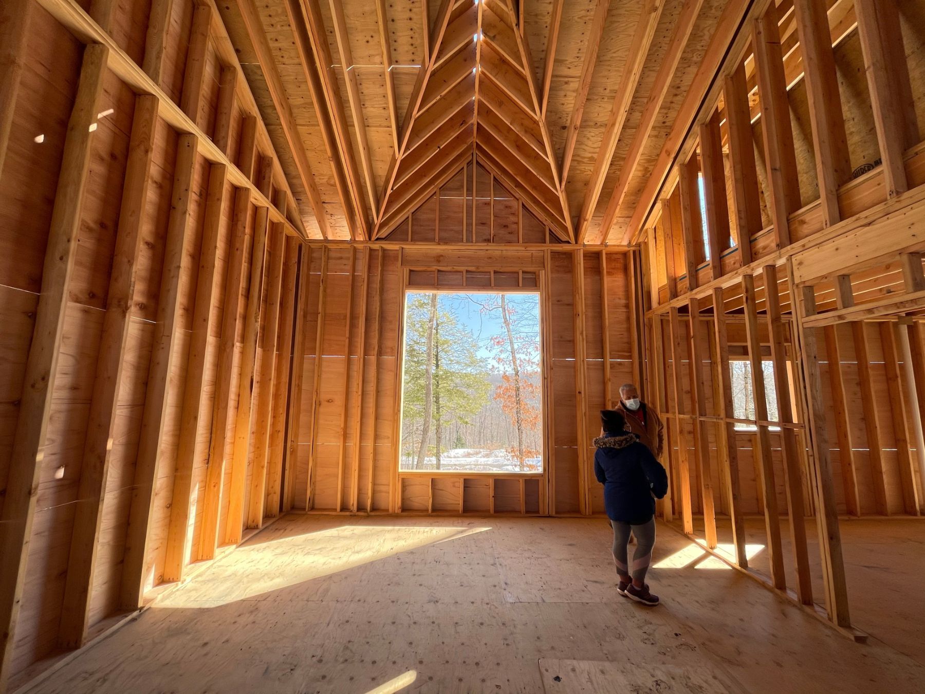 Sunlight pouring through the window of a newly framed home